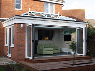 modern conservatory with bifold doors open